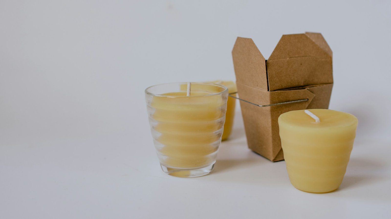 Selection of beeswax candles with simple packaging on a work surface