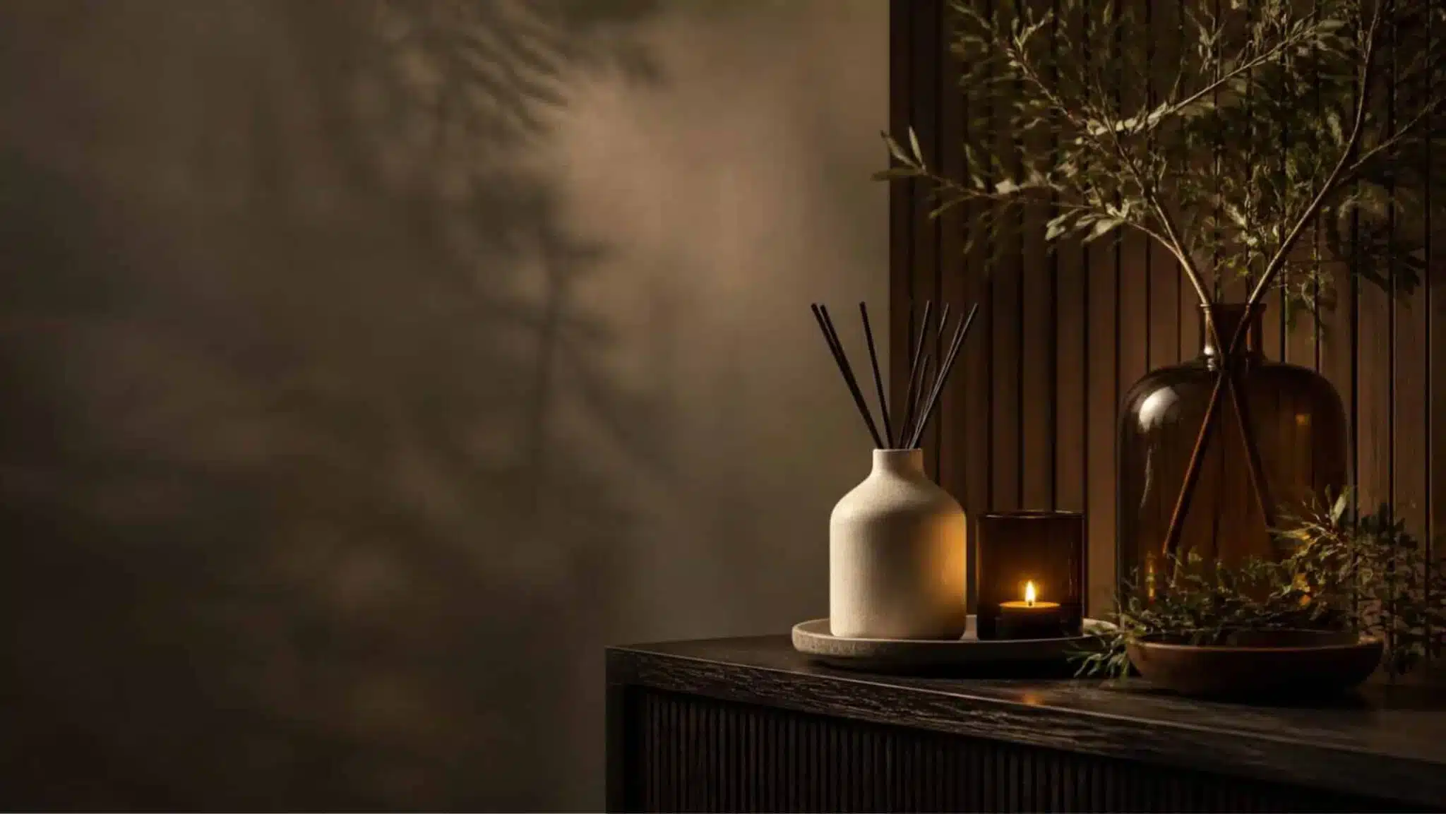 Candles, diffuser and fragrance objects styled in a warm interior